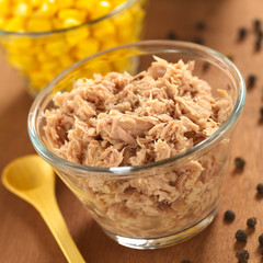 Canned tuna in glass bowl with sweet corn in the back