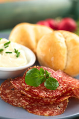 Thin salami slices with cream cheese and buns