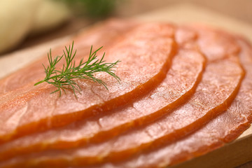 Thin smoked salmon slices garnished with dill
