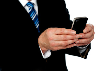 Cropped image of a man sending message