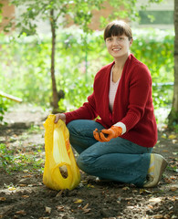 woman fertilizes the soil