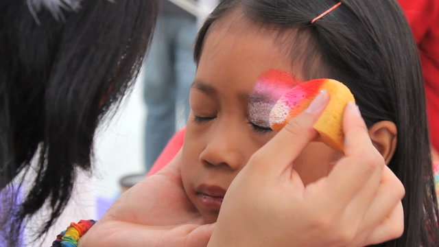 Little Asian Girl Has Eyes Face Painted