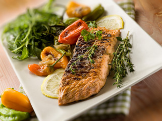 grilled salmon with capsicum and arugula, selective focus
