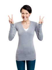 Smiley woman shows victory sign with two hands