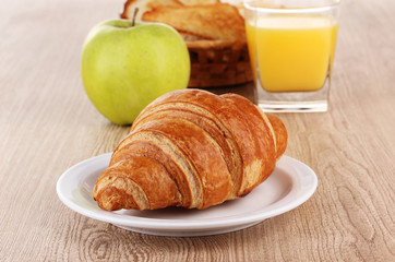 Classical breakfast. Orange juice and croissant
