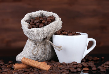Composition of canvas sack and the cup with coffee beans