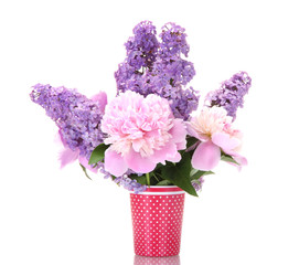 beautiful spring flowers in cup isolated on white