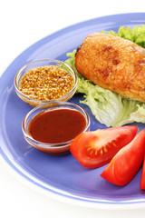Tasty meat cutlet with garnish on plate isolated on white