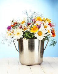 beautiful bouquet of bright  wildflowers in metal bucket,