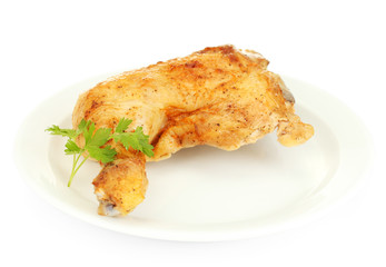roasted chicken leg with parsley in the plate isolated on white