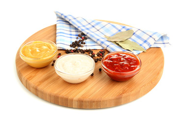 various sauces on chopping board isolated on white © Africa Studio