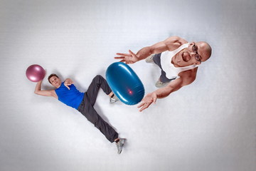 overhead view of two white men throwing balls