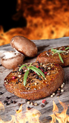 Delicious beef steaks with vegetable on wooden table