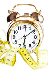 Alarm clock and measuring tape. Time to grow thin. 