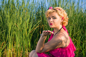 Beautiful pin-up woman blowing a kiss