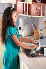 girl washing dishes in the kitchen