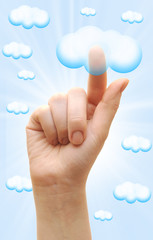 Woman hand touch the cloud against blue sky with clouds. finger
