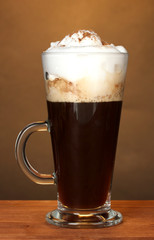 glass of coffee cocktail on brown background