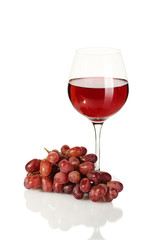 glass of wine and ripe grapes isolated on white