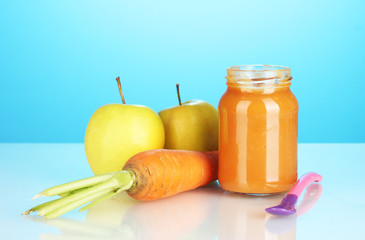 Jar with fruit and vegetables baby food and spoon