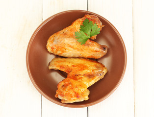 roasted chicken wings with parsley in the plate