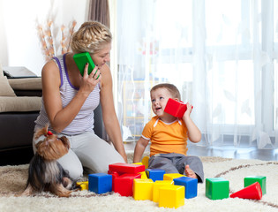 mother and kid boy role-playing together indoor