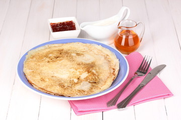 Stack of tasty pancakes on wooden background
