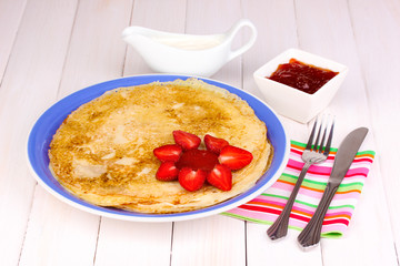 Stack of tasty pancakes on wooden background