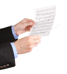 Fototapeta premium Music conductor hands with baton and notes isolated on white