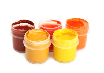 jars with multicolored gouache isolated on white background