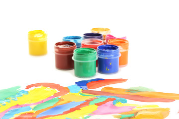 Jars with colorful gouache with a bright picture close-up