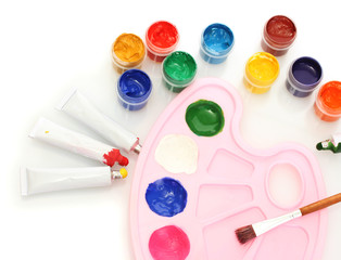 Tubes with colorful watercolors and jars with gouache and