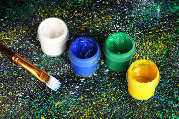 Jars with colorful gouache and brush