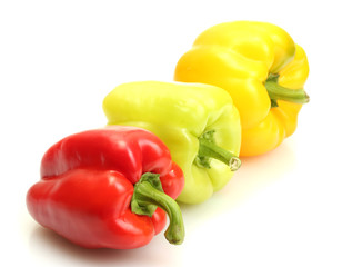 fresh yellow, red and green bell peppers isolated on white