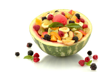 fresh fruits salad in watermelon and berries, isolated on white