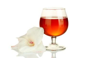 glass with cocktail and gladiolus bud isolated on white