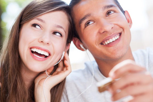 Young Couple Listening Music Together