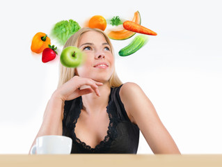 Young beautiful woman with vegetables, berries and fruits flying