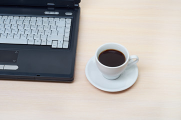 laptop with fresh cup of coffee and notebook