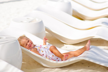 cute little girl have a rest at tropical beach background