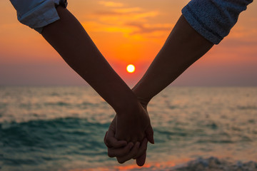 Couple Holding Hands at Sea Sunset - 43998877