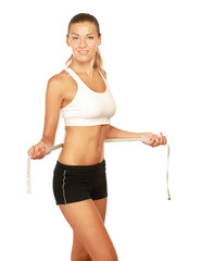 A young woman measuring her waist isolated on white background