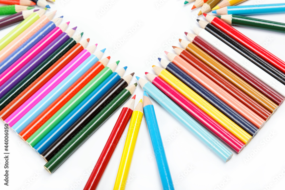 Wall mural Close up of color pencils with different color over white backgr