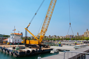 Fototapeta na wymiar Crane working in port of Barcelona.