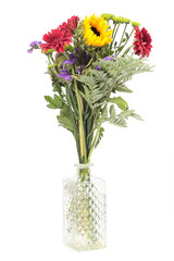 Mixed flowers in vase to white background