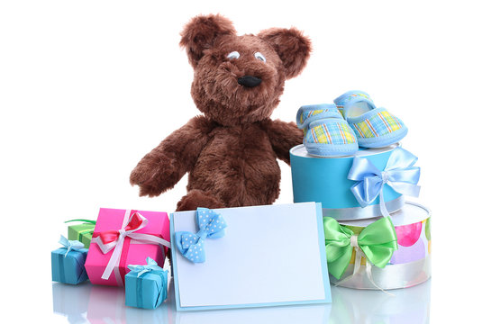 beautiful gifts, baby's bootees and bear toy  isolated on white