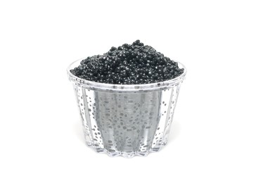 Fototapeta na wymiar Black caviar in a glass on a white background