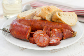 sausages with bread on the white plate