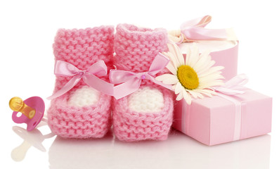 pink baby boots, pacifier, gift and flower isolated on white