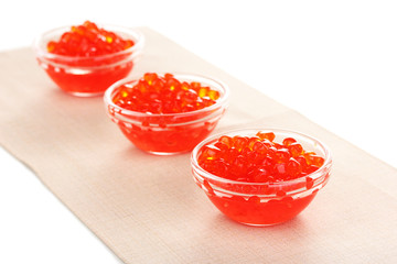 Red caviar in glass bowls isolated on white